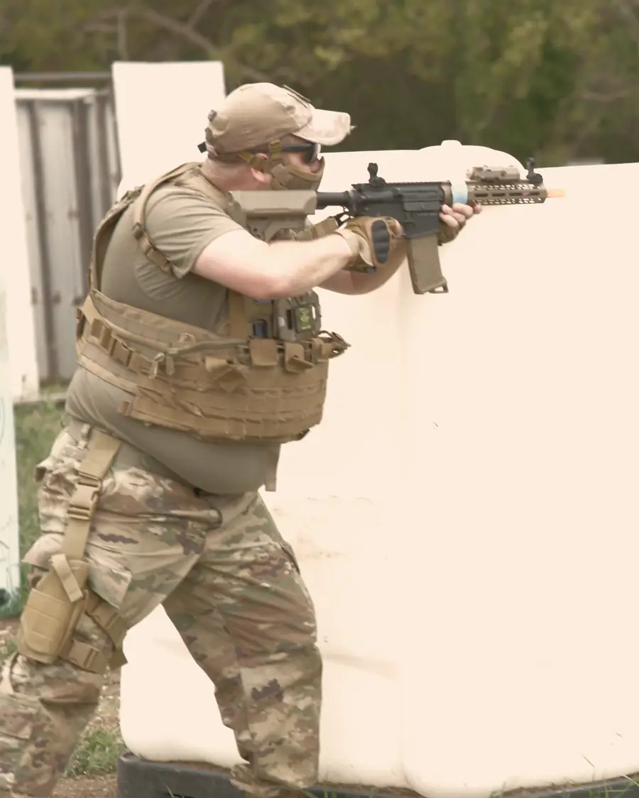 A player aims around a white barricade